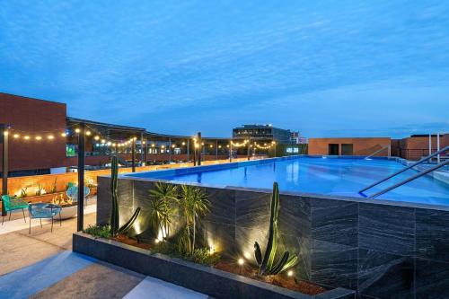 a large swimming pool on top of a building at Aloft Guadalajara Sur in Guadalajara