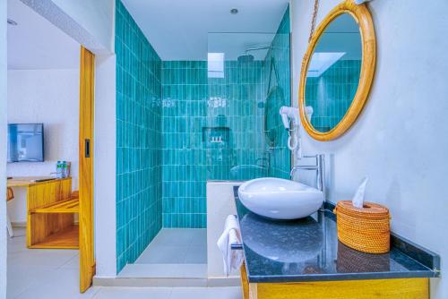 a bathroom with a sink and a glass shower at Hôtel AFRICA QUEEN in Somone