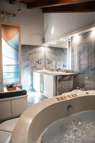 a bathroom with a tub and a sink at La Residenza Isabella in Milan