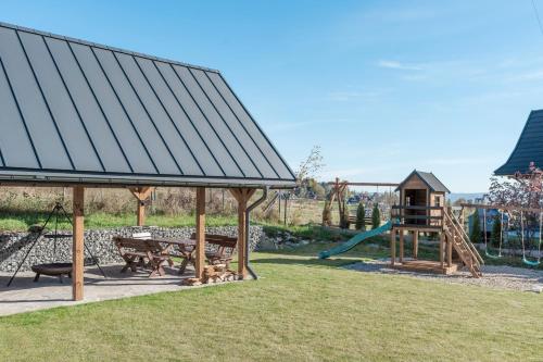 a park with a playground with a slide at Wierchy View - LoftAffair Collection in Kościelisko
