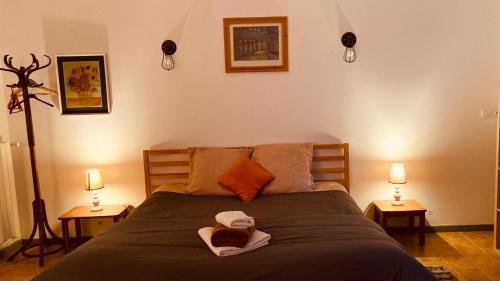 a bedroom with a bed with two towels on it at Métairie de Moutiques in Cazaubon