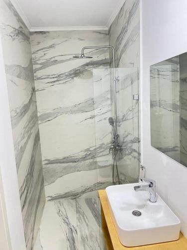a bathroom with a sink and a shower at Opera Boutique Hotel in Tbilisi City