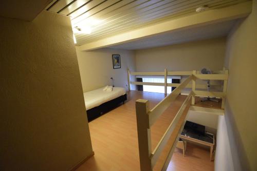 a room with a bunk bed and a staircase at Condo Gardens Leuven in Leuven