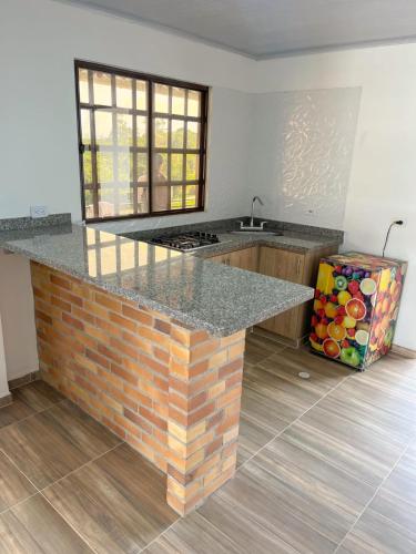 a kitchen with a brick counter top in a room at Cabaña en la mesa De los Santos in Los Santos