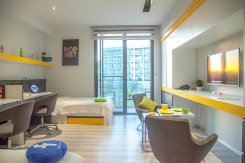 a bedroom with a bed and a desk and chairs at Five Star Memories in Famagusta in Mağusa