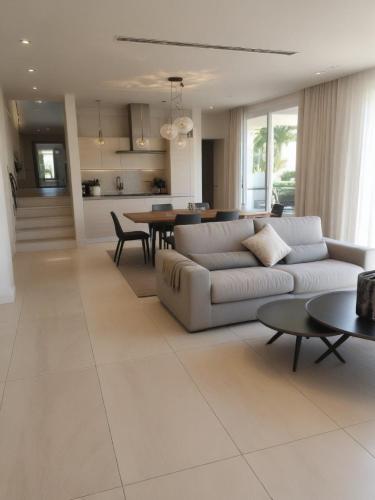 a living room with a couch and a table at Seaview Luxury Villa Jacuzzi & Pool! 2 Min Beach in Protaras