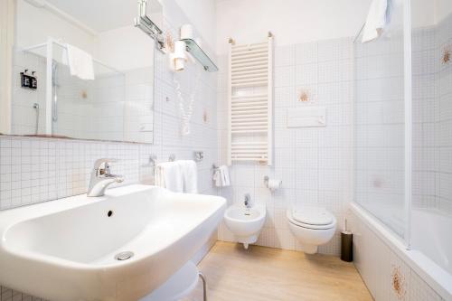 a white bathroom with a sink and a toilet at Best Quality Hotel Gran Mogol in Turin
