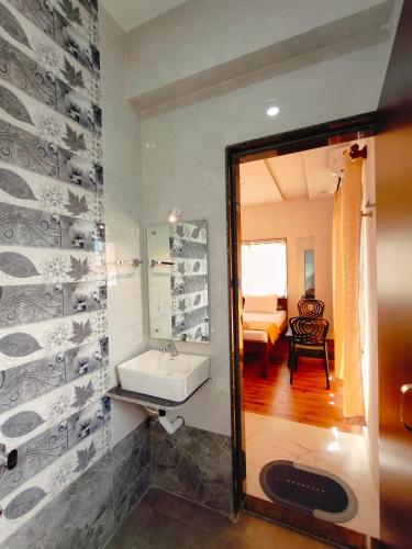a bathroom with a sink and a mirror at Shiv Shakti in Alibaug