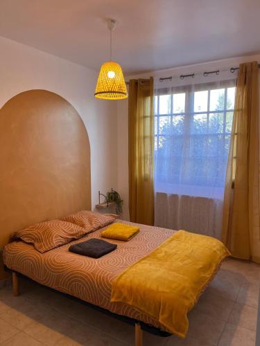 Ένα ή περισσότερα κρεβάτια σε δωμάτιο στο Appartement La Marmotte Compreignac