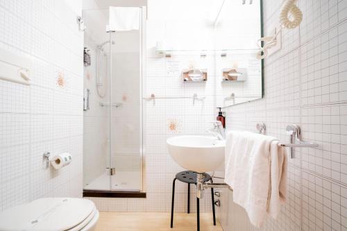 a white bathroom with a sink and a toilet at Best Quality Hotel Gran Mogol in Turin