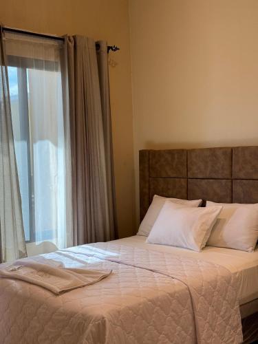 a bedroom with a bed with a window and a bedspread at Hotel Margarita in Flores