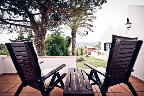two chairs sitting on a porch with a table at Quinta Verde Sintra - Casa de Campo in Sintra
