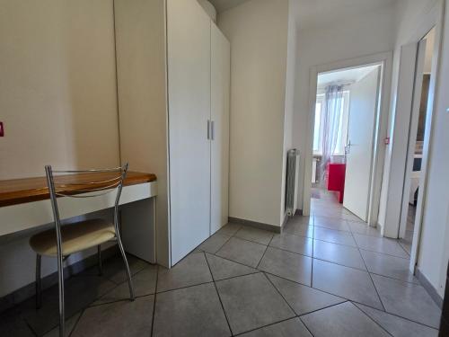 a room with a chair and a desk and a hallway at B&B FR House Affittacamere Colleferro in Colleferro