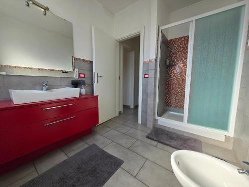 a bathroom with a white sink and a red cabinet at B&B FR House Affittacamere Colleferro in Colleferro
