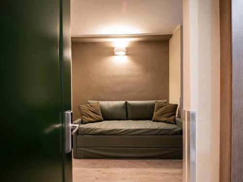 a couch in a room with a light on the wall at Best Quality Hotel Gran Mogol in Turin