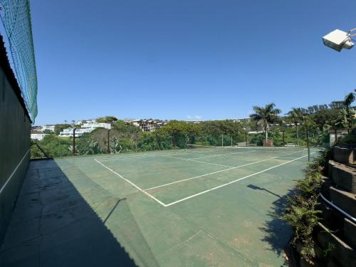a tennis court with a net on top of it at Ballito Bliss Chalet at Chaka's Rock Chalets 9 in Ballito