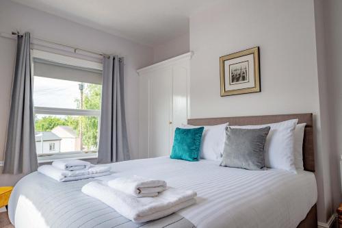 a bedroom with a large bed with towels on it at Host & Stay - Cannon Apartment in Worcester