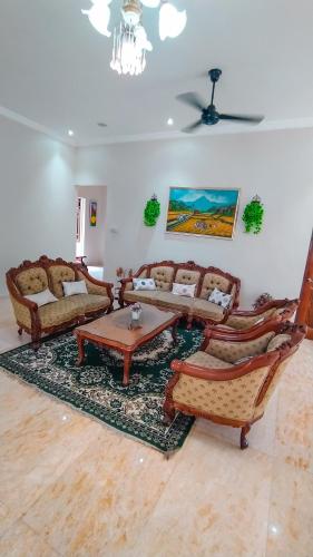 a living room with couches and a table at ndalem singgah malioboro by abiza in Demangan