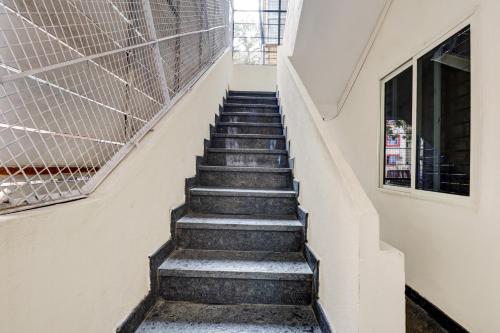 a staircase in a building with a window at Super Hotel O PM Hotels in Bengaluru