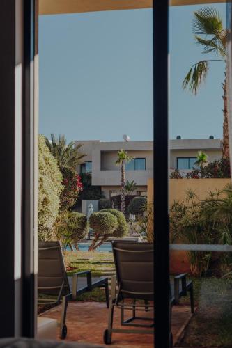 a view of a patio with chairs and a building at Sirayane Boutique Hotel & Spa Marrakech in Marrakesh