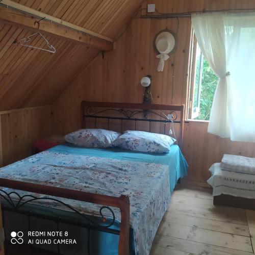 a bedroom with a bed in a room with a window at Holiday chalet in Batumi