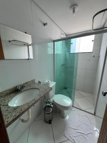 a bathroom with a shower and a toilet and a sink at Domus Hotel Cidade Nobre - Ipatinga in Ipatinga