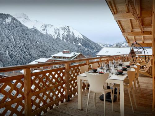 a table on a balcony with a view of mountains at Penthouse Barbossine - OVO Network in Châtel