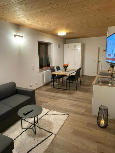 a living room with a couch and a table at Ferienwohnungen Obert in Karlstadt