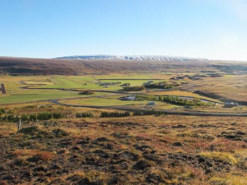 an aerial view of a golf course in the hills at Breidamyri Farm Apartments in Laugar