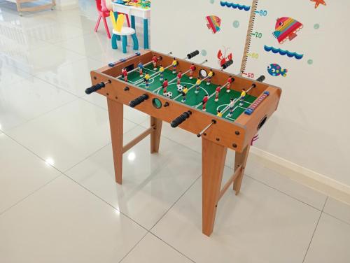 a wooden foosball table in a childs room at Legoland walk 3min D'Pristine Rejoice Suite 2B2R 8pax Lakeview in Nusajaya