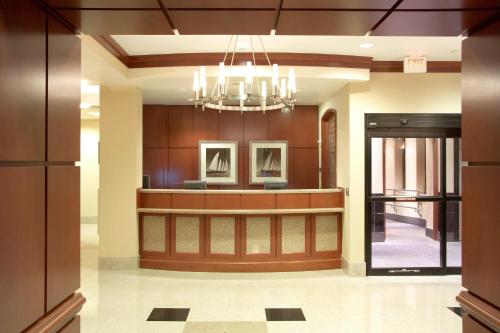 a lobby with a reception desk and a chandelier at Courtyard Boston Copley Square in Boston