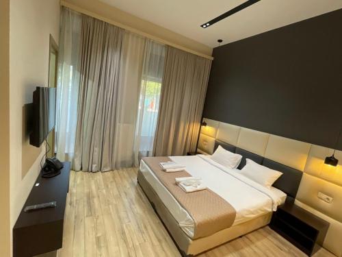 Postel nebo postele na pokoji v ubytování History Hotel Tbilisi