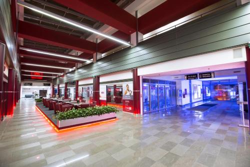a lobby of a building with couches and windows at Hotel Magnus Trenčín in Trenčín