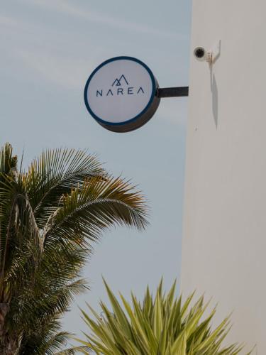 a sign for a marfa hangs above a palm tree at Narea San Bartolo in San Bartolo