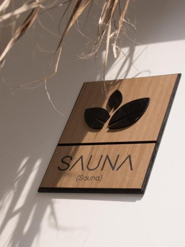 a wooden sign with two spoons on it at Narea San Bartolo in San Bartolo