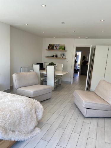 a living room with a couch and a table at The bay apartment in Stone Grove