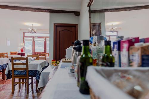 a table with bottles of wine sitting on top of it at Casa Rural Altzibar-berri in Urnieta