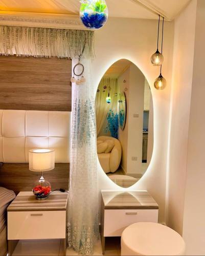 a bedroom with a mirror and a bed with a table at ايارو نوب-iaru nub in Dahab