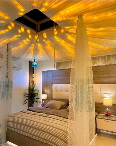 a bedroom with a bed with a yellow ceiling at ايارو نوب-iaru nub in Dahab