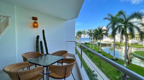a balcony with a table and chairs and a view of the ocean at Estudio Marino in Nuevo Vallarta