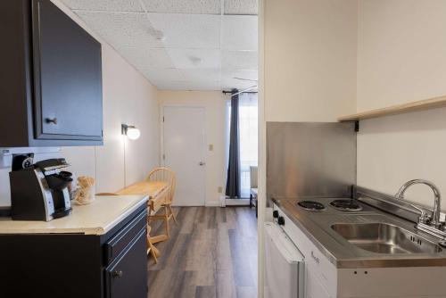 a kitchen with a sink and a counter top at Ocean House Boutique Hotel & Motel in Old Orchard Beach