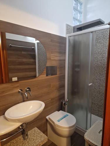 a bathroom with a toilet and a sink and a shower at Spiagge Iblee in Marina di Ragusa