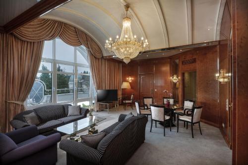 a living room with furniture and a chandelier at Maritim Hotel Bad Wildungen in Bad Wildungen