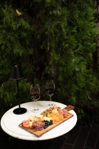 a plate of food on a table with two glasses of wine at Atemporal by Andean in Lima