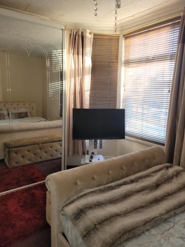 a living room with a couch and a mirror at Southfield lodge in Middlesbrough