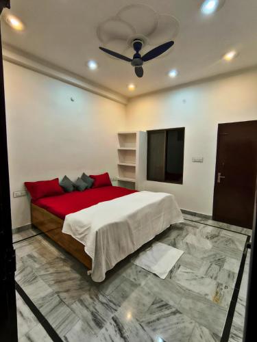 a bedroom with a large bed and a flat screen tv at Siddhi Homestay in Varanasi