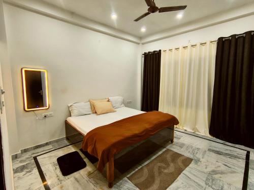 a bedroom with a bed with a brown blanket on it at Siddhi Homestay in Varanasi