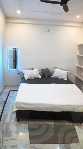 a bedroom with a large white bed in a room at Siddhi Homestay in Varanasi