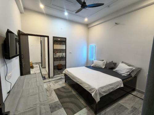 a bedroom with a bed and a ceiling fan at Siddhi Homestay in Varanasi