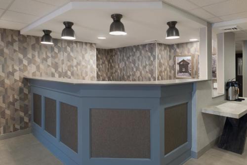 a lobby with a blue counter in a room at Holiday Inn Express South Burlington - Downtown by IHG in Burlington